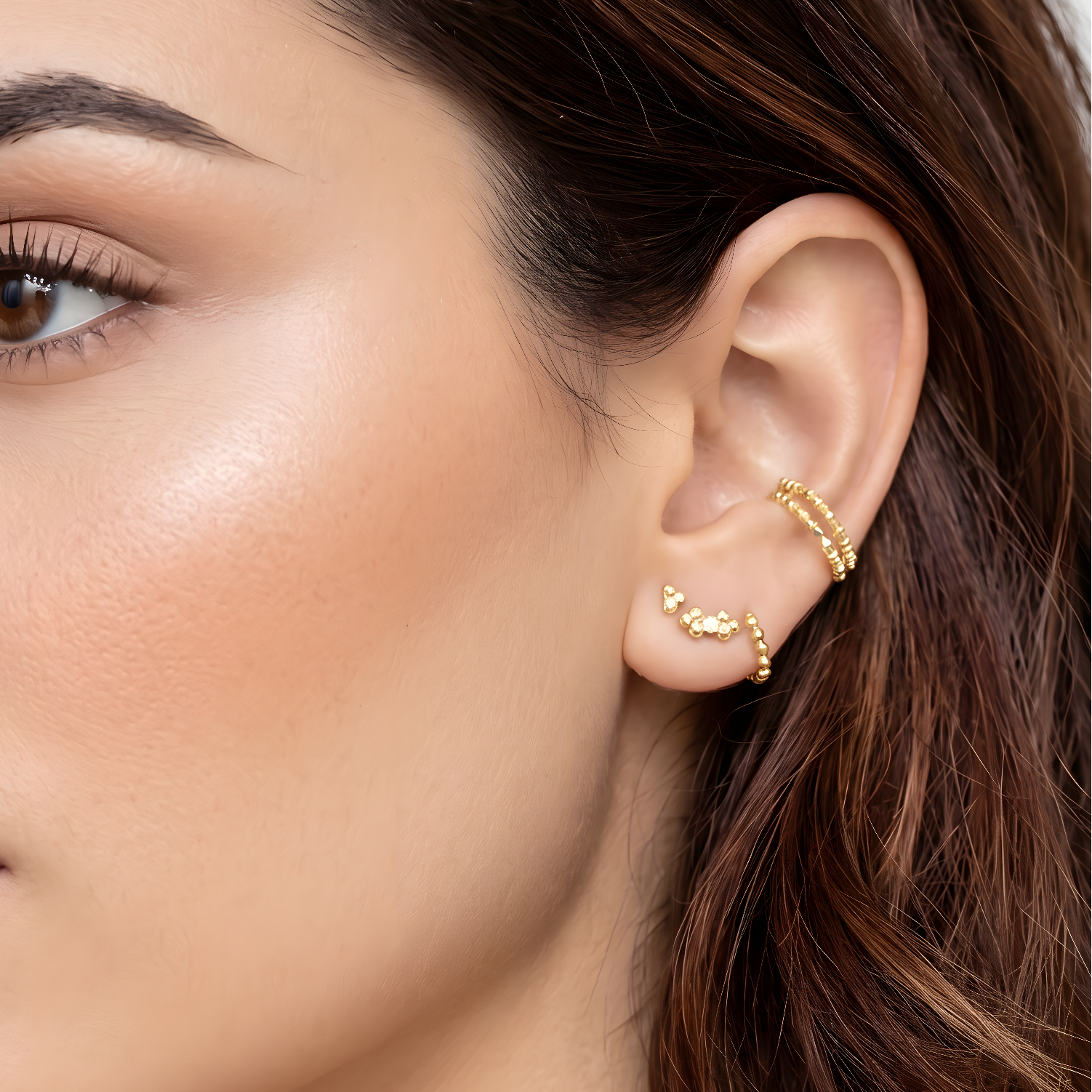 woman wearing gold earrings