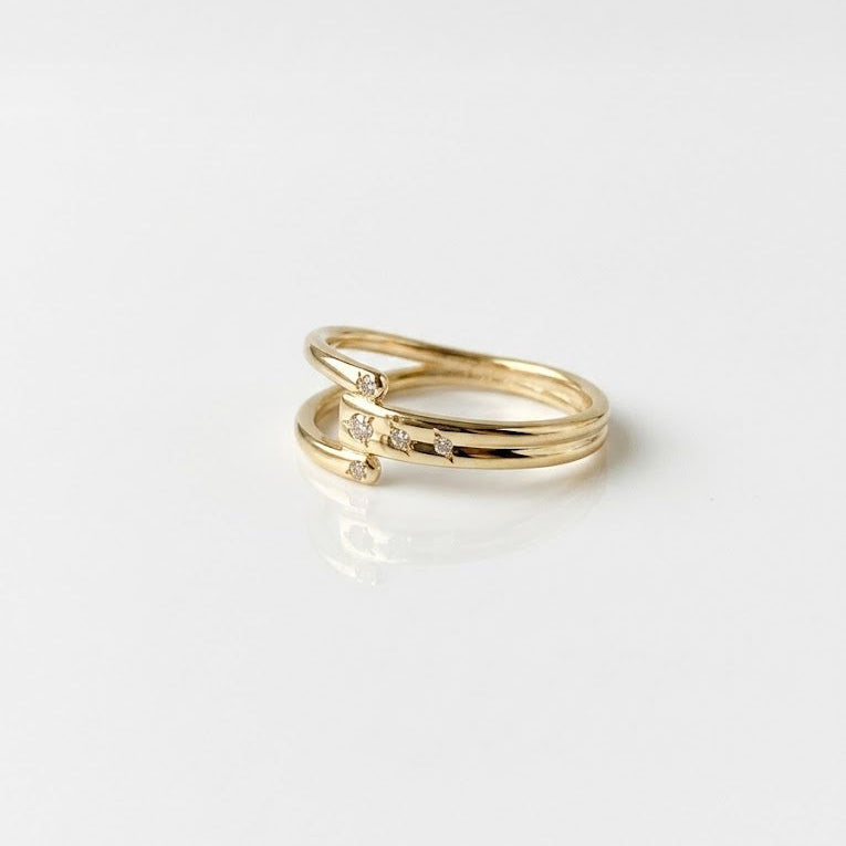 Gold ring with small diamonds on a white background