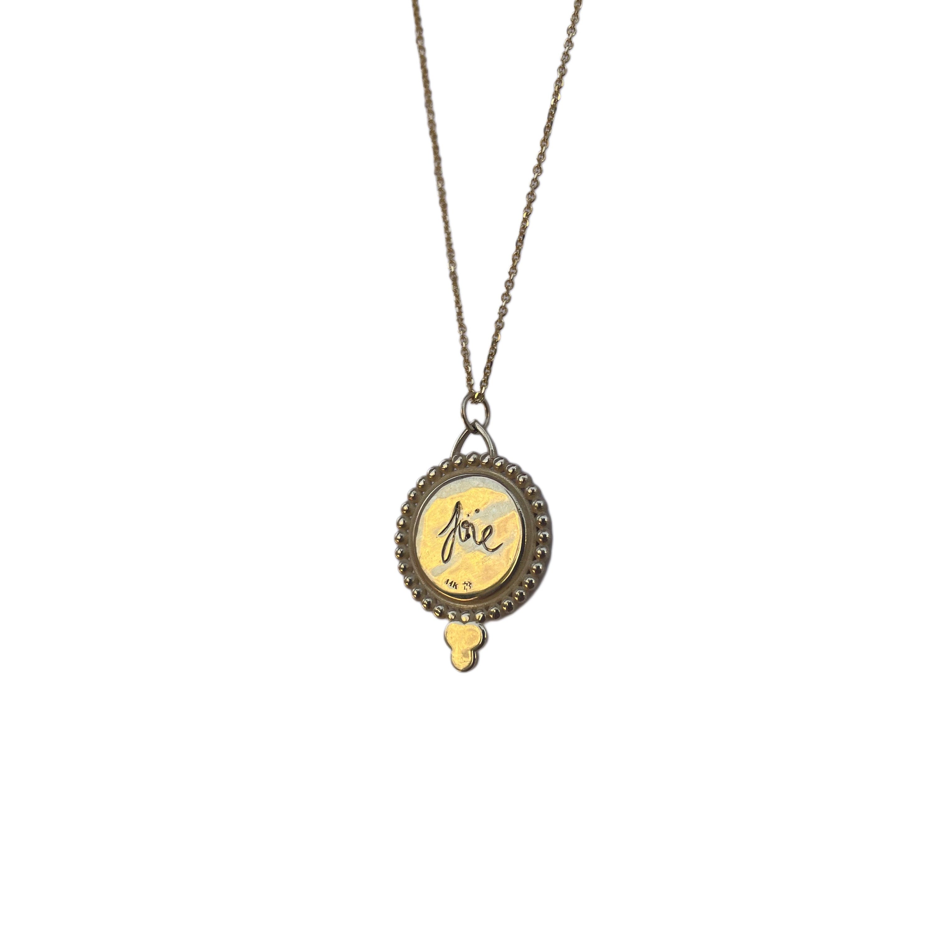 Necklace with a round engraved pendant on a white background