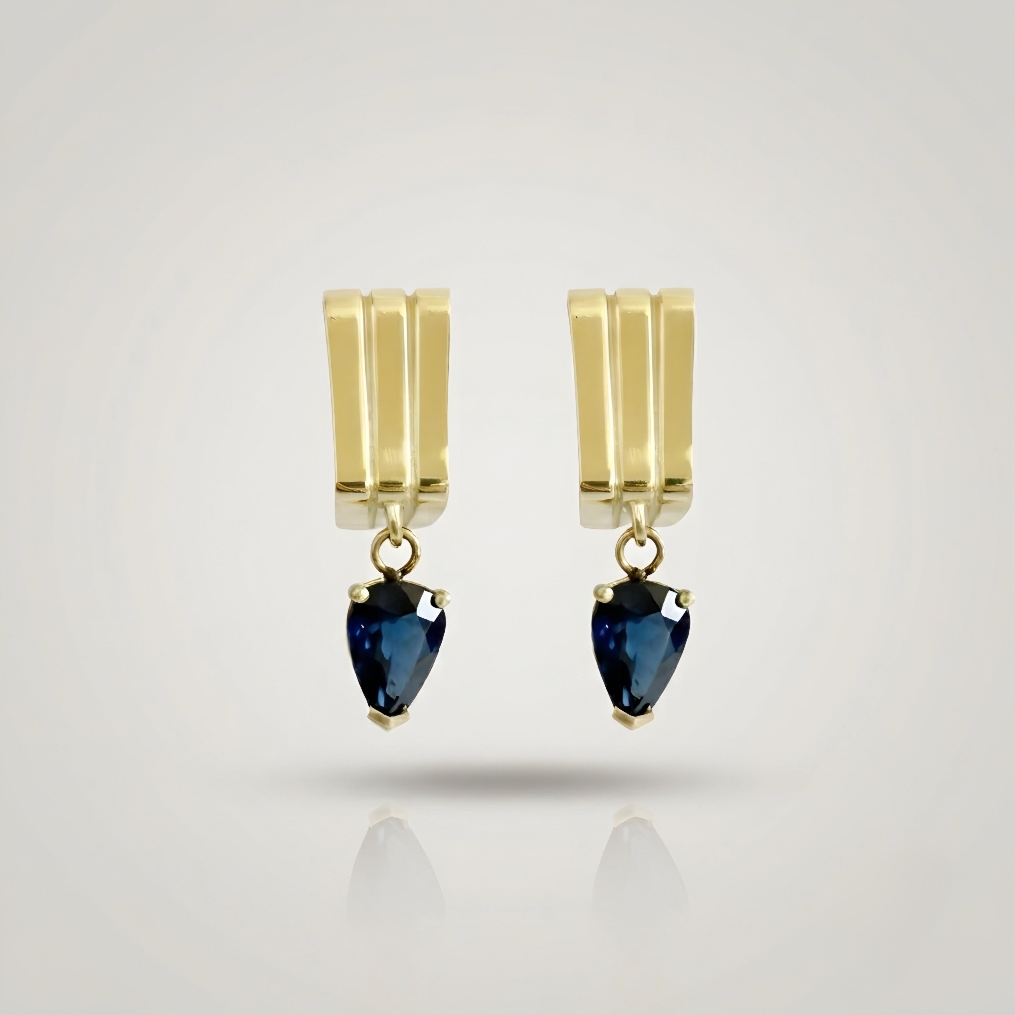 Yellow gold earrings with dark blue sapphire drop